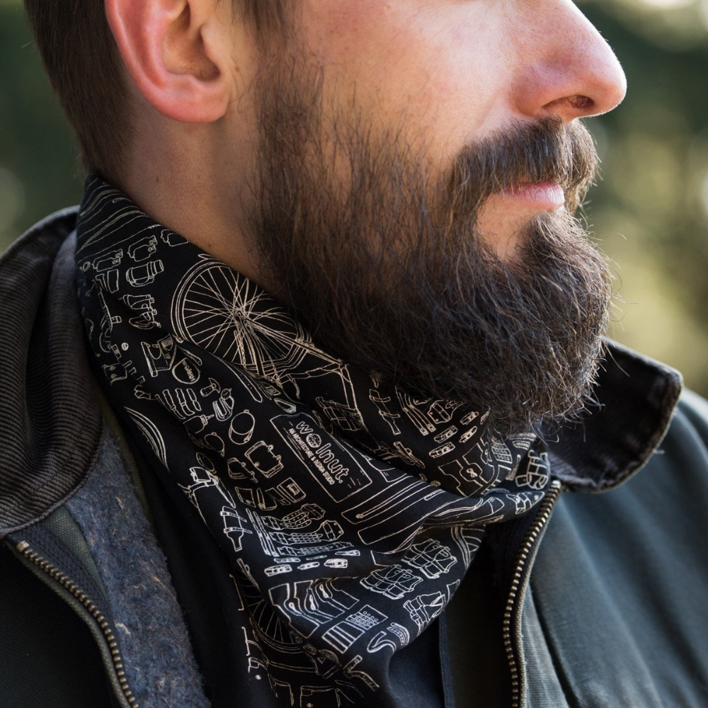 Man wearing black bicycle print bandana around neck