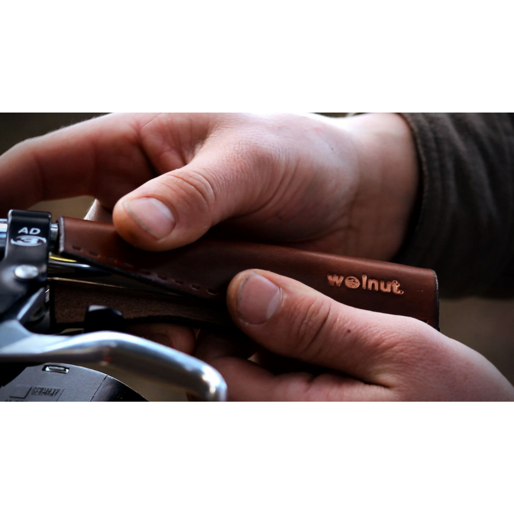 Installation photo showing a man holding up a city grip to handlebar to indicate it gets installed with needle and thread