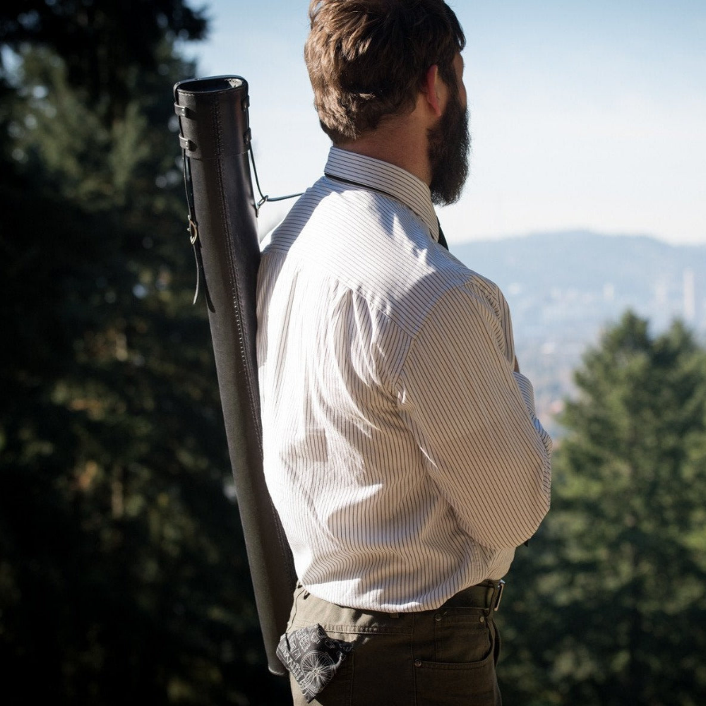 Side view of man wearing the black leather variant of the poster case over his shoulder